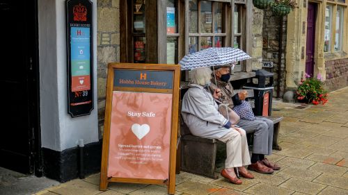 Elderly couple on bench on street