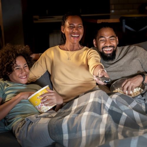 Photo of family enjoying a movie at home